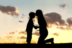 stock-photo-silhouette-of-a-young-mother-lovingly-kissing-her-little-child-on-the-forehead-outside-isolated-in-190648280